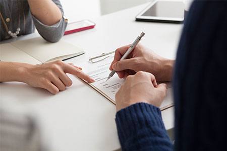 real estate finance careers professional helping applicant with contract