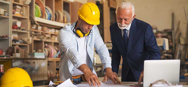 two men looking at as-built documents