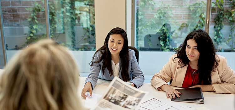 three female project managers reviewing copy