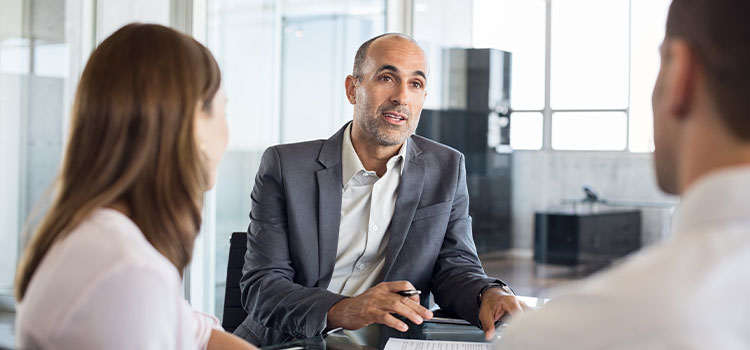 a professional advises a couple at a conference table