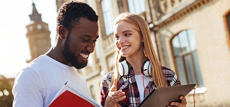 Two students talk as they walk on campus
