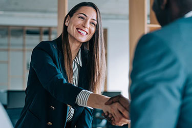 woman shakes hands with male client