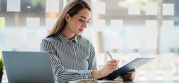 woman actuary assesses risk on client file