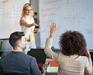 woman asking questions in business class