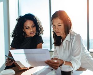 two women review spreadsheets together